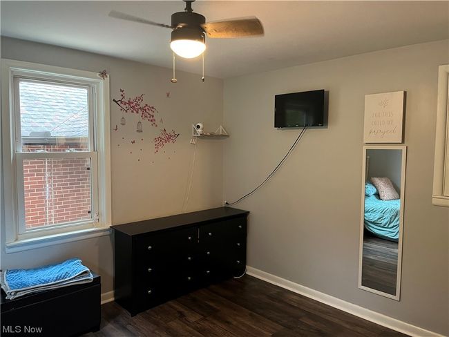 Bedroom featuring dark hardwood / wood-style flooring and ceiling fan | Image 20