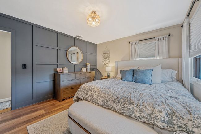 Bedroom with light wood-type flooring | Image 17
