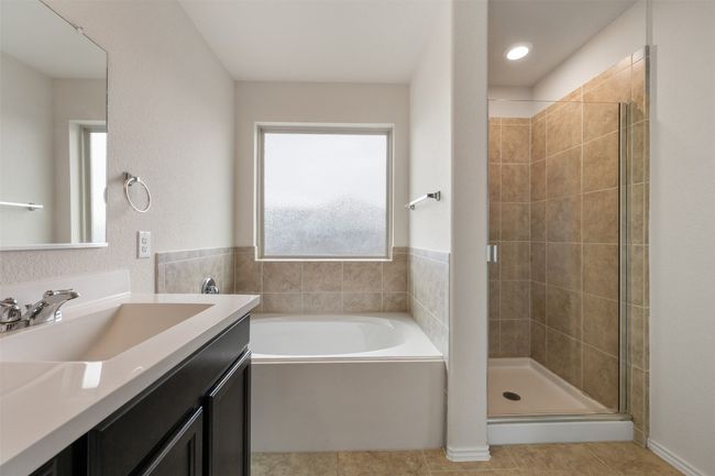 Bathroom featuring a stall shower, a bath, vanity, and tile patterned flooring | Image 27