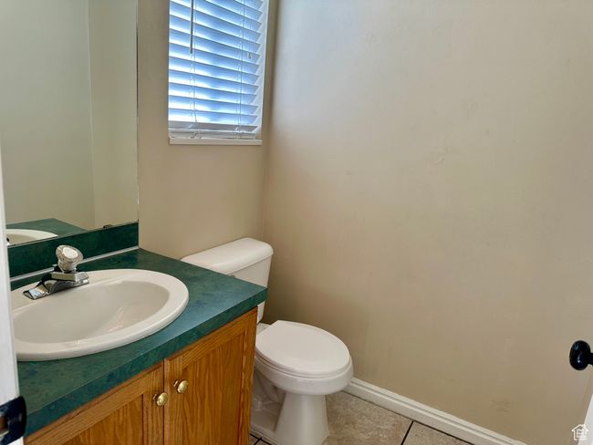 Half bathroom featuring vanity and tile patterned floors | Image 13