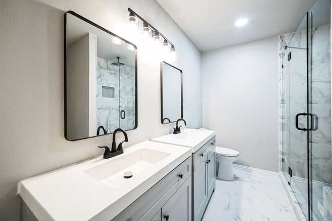 Bathroom with marble finish floor, a marble finish shower, and a sink | Image 8
