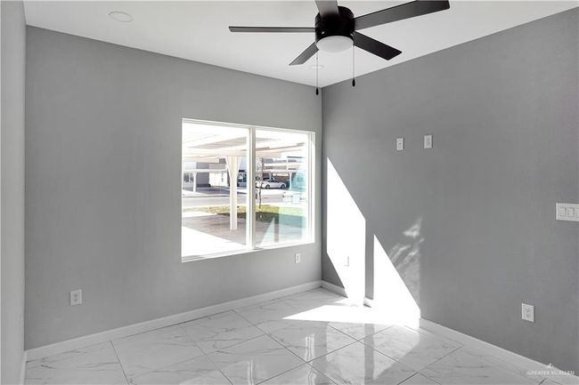 Unfurnished room featuring baseboards, marble finish floor, and a ceiling fan | Image 14