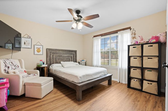 Bedroom featuring light wood-style flooring and ceiling fan | Image 14