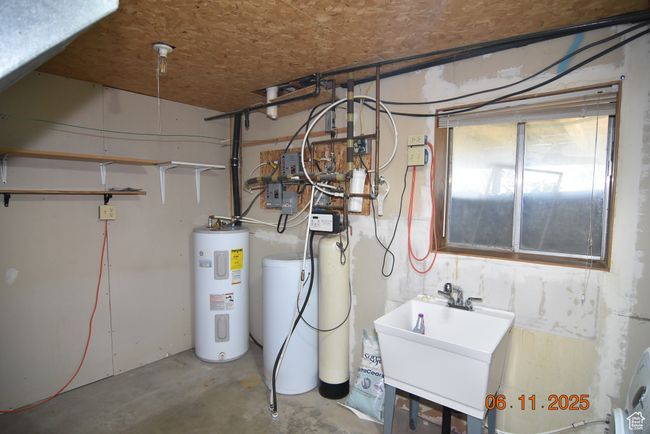 Utilities featuring water heater and a sink | Image 56