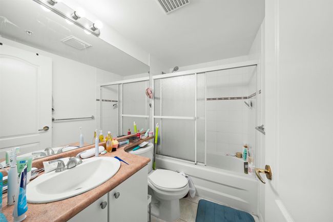 Bathroom featuring visible vents, tile patterned flooring, vanity, and toilet | Image 9