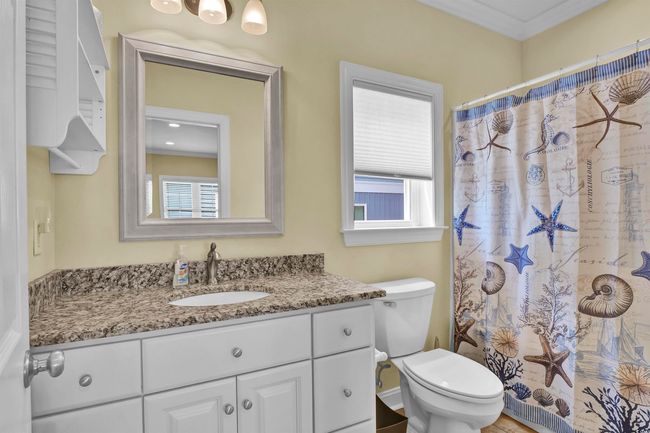 Full bathroom featuring vanity, plenty of natural light, ornamental molding, and curtained shower | Image 13