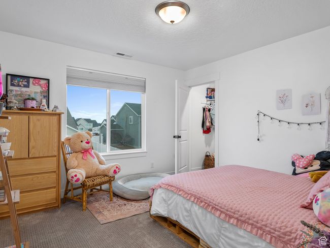 Carpeted bedroom with a closet and a textured ceiling | Image 36