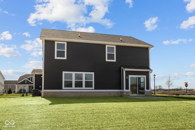 back of house featuring central AC unit and a yard | Image 30