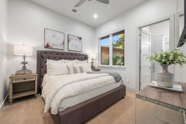 Downstairs Bedroom featuring light colored carpet, a ceiling fan, visible vents, recessed lighting, and baseboards | Image 23