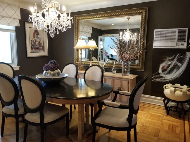 Dining area featuring baseboards, a notable chandelier, and crown molding | Image 13