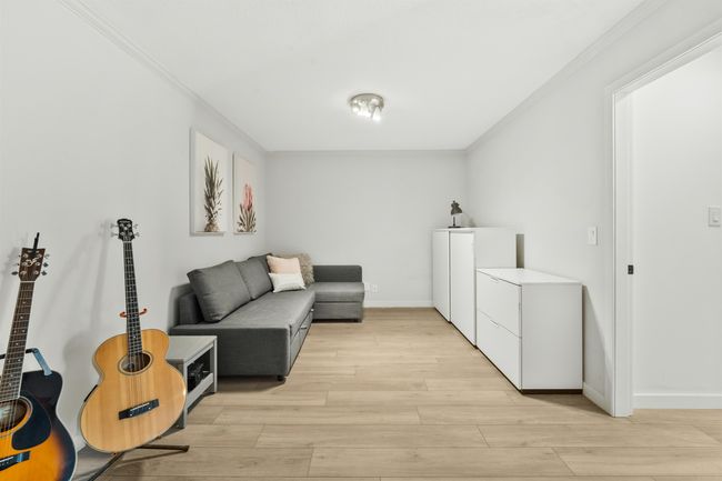 Interior space with light wood-type flooring, crown molding, and baseboards | Image 14