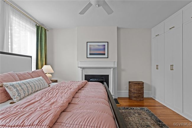 Bedroom with a fireplace, wood finished floors, and a ceiling fan | Image 19