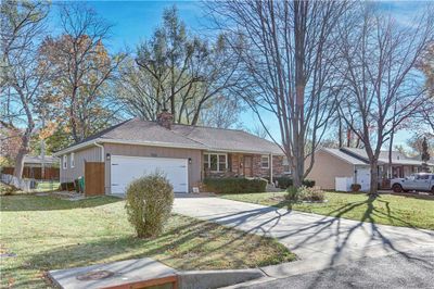 Ranch-style house with a garage and a front lawn | Image 3