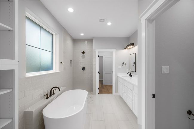 Bathroom featuring vanity and separate shower and tub | Image 17