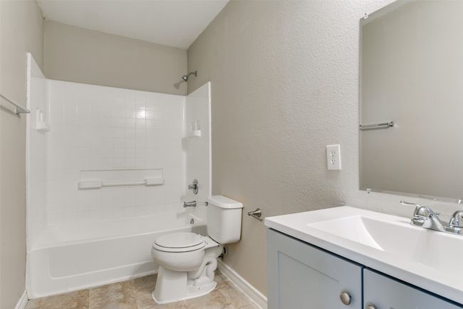 Full bathroom featuring vanity, bathtub / shower combination, and toilet | Image 17