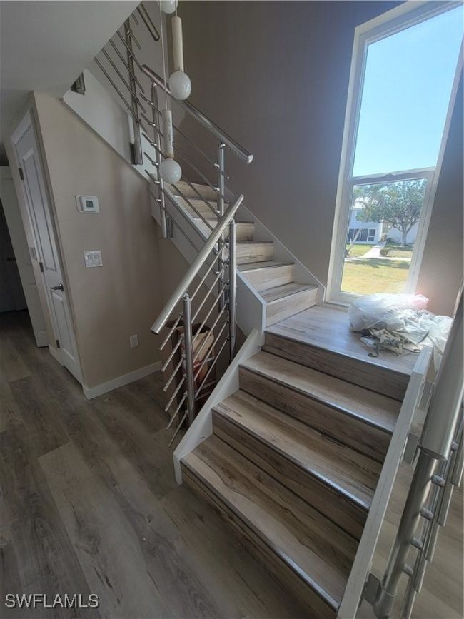 Stairs featuring natural light through window | Image 16