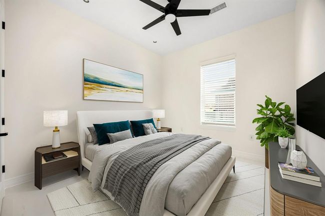This cozy secondary bedroom offers a tranquil atmosphere with soft neutral tones, abundant natural light, and modern design touches. Highlights include sleek tile flooring, a stylish ceiling fan, and ample space for comfort and functionality—ideal for guests, a home office, or a peaceful retreat. | Image 29
