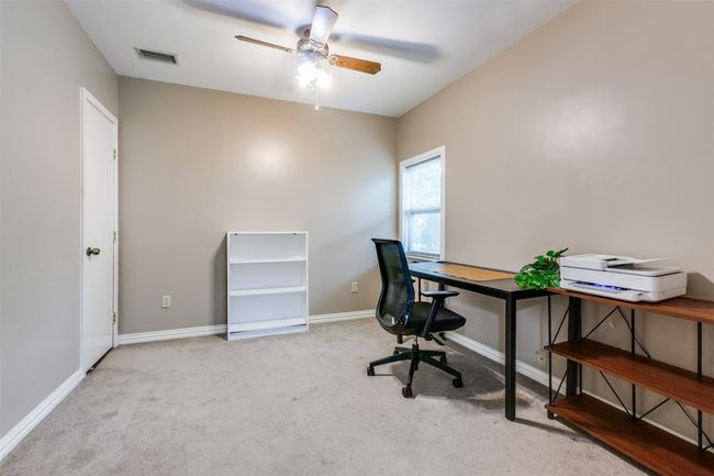 Carpeted home office featuring ceiling fan and baseboards | Image 6