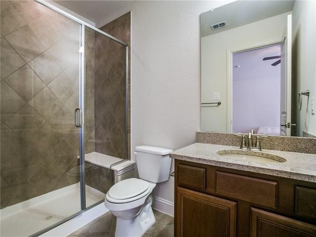 Full bathroom featuring vanity, toilet, a shower stall, and baseboards | Image 17