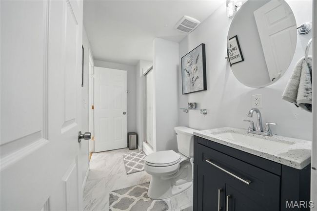 Bathroom with vanity, a stall shower, and marble look tile flooring | Image 22