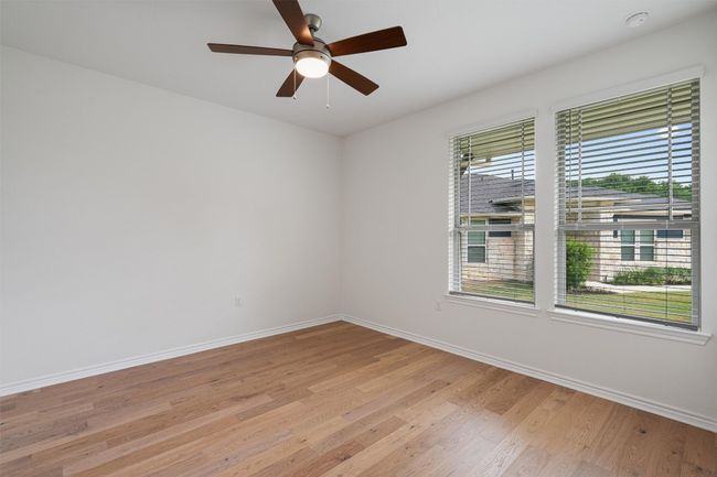 Second bedroom with picture windows and wood flooring. | Image 17