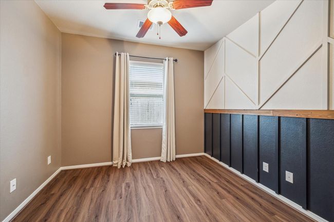 Secondary bedroom featuring elegant wall molding enhances the room's modern charm. | Image 28