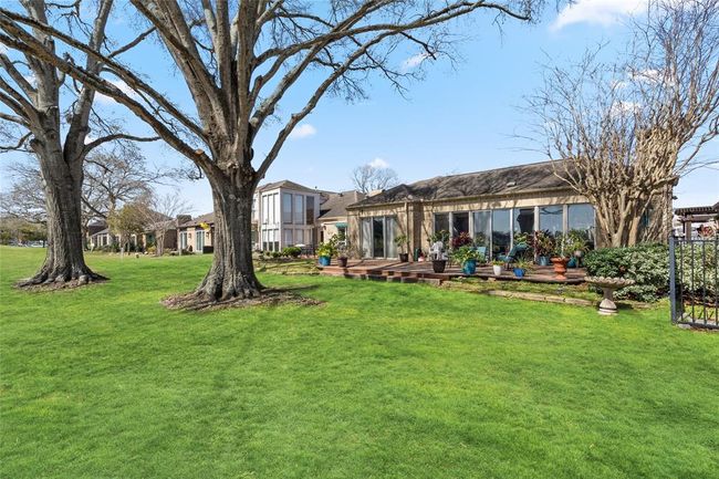 Enjoy breathtaking golf course views from this stunning home, featuring a spacious backyard with mature trees, a well-maintained lawn, and a charming wooden deck perfect for outdoor living. Don't miss this rare opportunity to own a home with such an incredible setting! | Image 39
