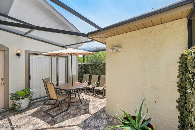 View of patio / terrace featuring a lanai, a sunroom, and outdoor dining space | Image 4