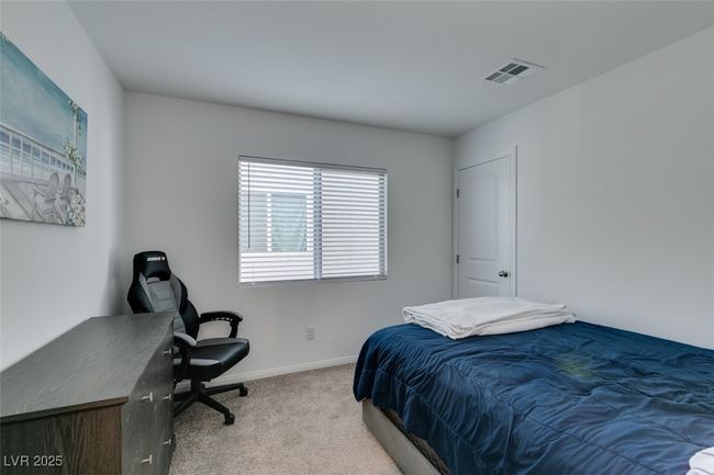 Carpeted bedroom featuring baseboards and visible vents | Image 18