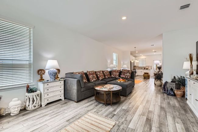 Living area featuring light wood-style flooring and recessed lighting | Image 6