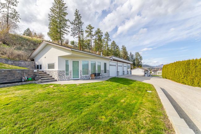 Secondary suite (closest) with attached 3 car garage | Image 10