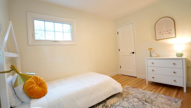 The third upper level bedroom, staged as a childs' room, could also make for an excellent office. Its corner location includes north- and east-facing windows, a new light fixture, refinished original white oak hardwood floors and fresh paint. | Image 15