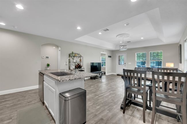 Kitchen featuring dishwasher, visible vents, a tray ceiling, and a sink | Image 14