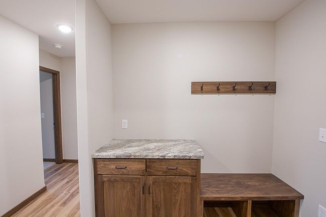 Bench, hooks, and drop zone counter compose a convenient entry from the garage | Image 18