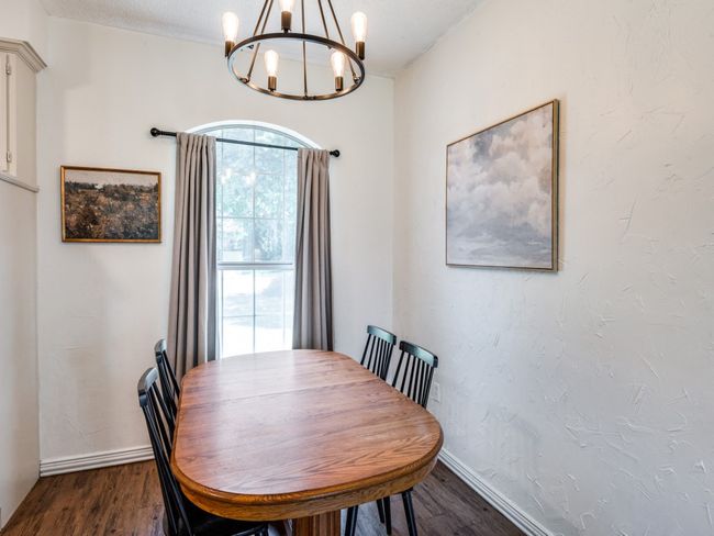 Dining space with a chandelier and dark wood-style floors | Image 13