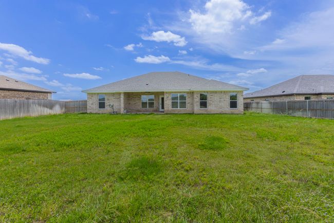 Rear view of property featuring a fenced backyard, brick siding, and a shingled roof | Image 22