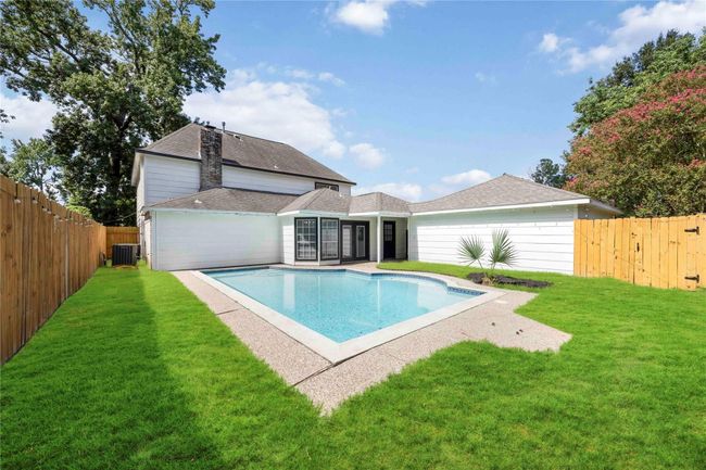 Relax in the Texas heat by the pool, surrounded by a lush green lawn and a private fenced backyard. | Image 4