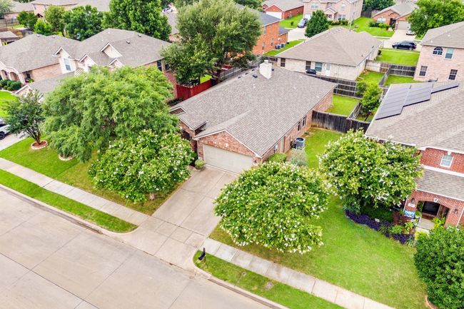 Bird's-eye view of the home and surrounding neighborhood, highlighting the spacious lot, shaded front yard, and private backyard area. | Image 4