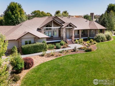 As you approach the home, a sprawling wrap around front porch stretches across the entire facade, beckoning you to find a seat and soak in the breathtaking Mountain Views that paint the horizon. | Image 2