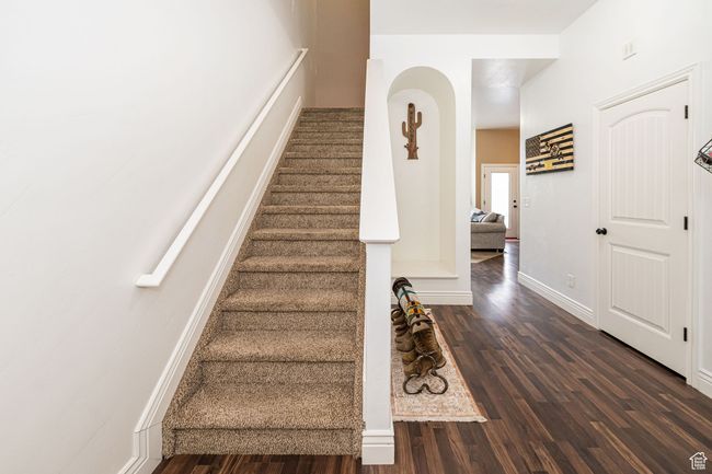 Stairs with wood finished floors and baseboards | Image 5