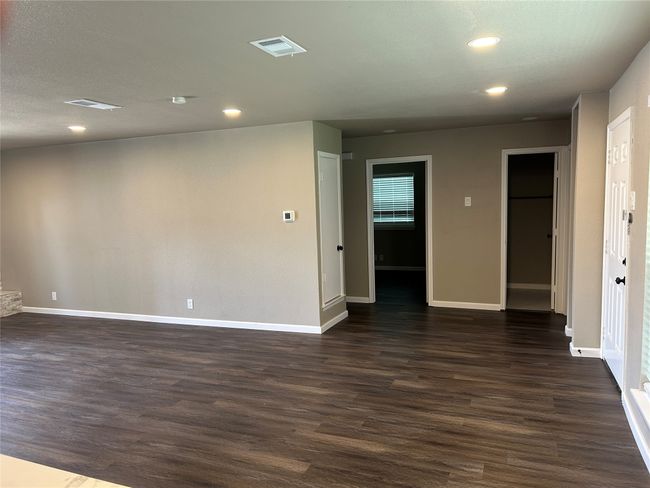 Spare room with dark wood-style floors, baseboards, and recessed lighting | Image 10