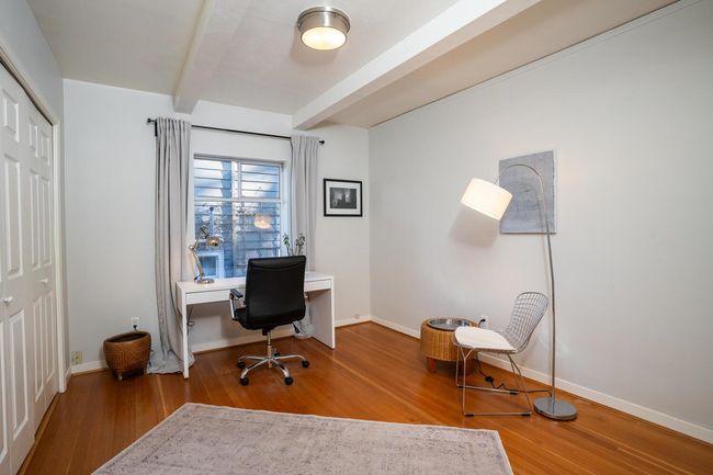 Office area featuring wood finished floors, baseboards, and beam ceiling | Image 13