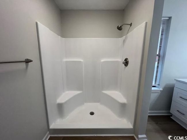 Bathroom featuring vanity, baseboards, and a shower | Image 13