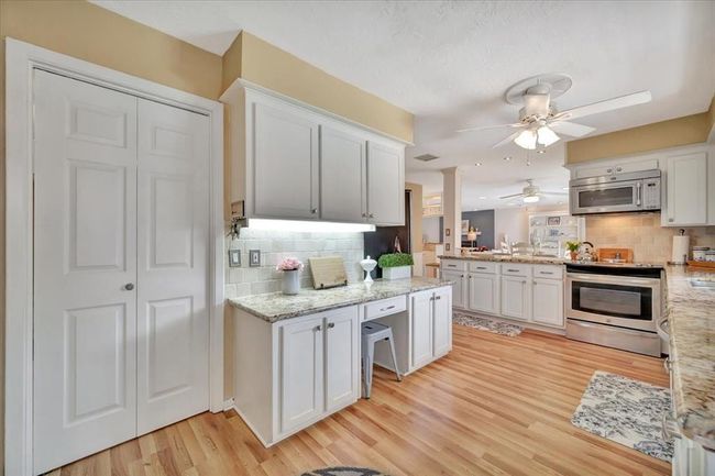 Another view of the kitchen with a formal dining room just through the door. | Image 19