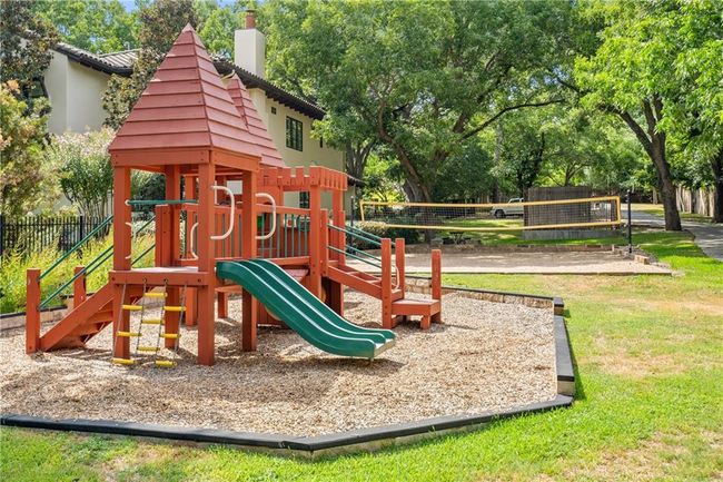 Community playground featuring view of scattered trees | Image 23