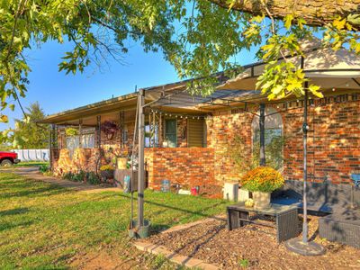 View of front of home featuring a front yard outdoor seating area | Image 3