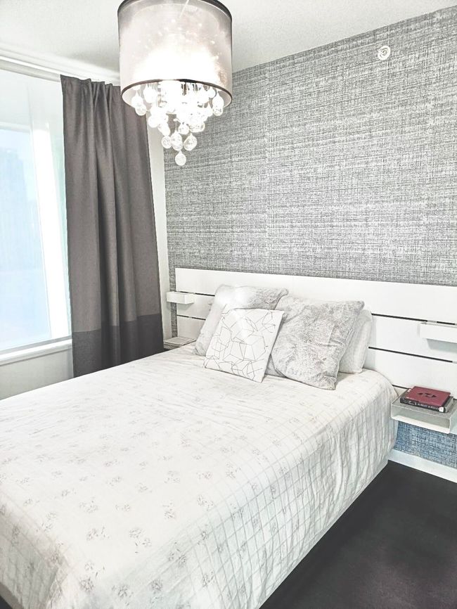 Bedroom with a chandelier | Image 5