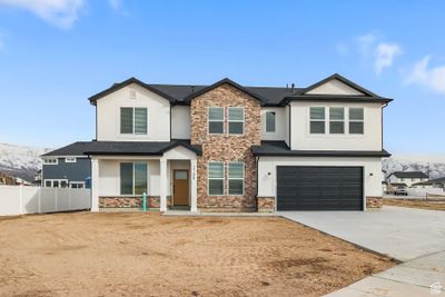 View of front facade featuring a garage | Image 1