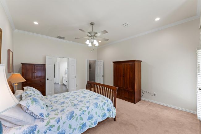 Bedroom with ornamental molding, recessed lighting, light carpet, and ceiling fan | Image 18