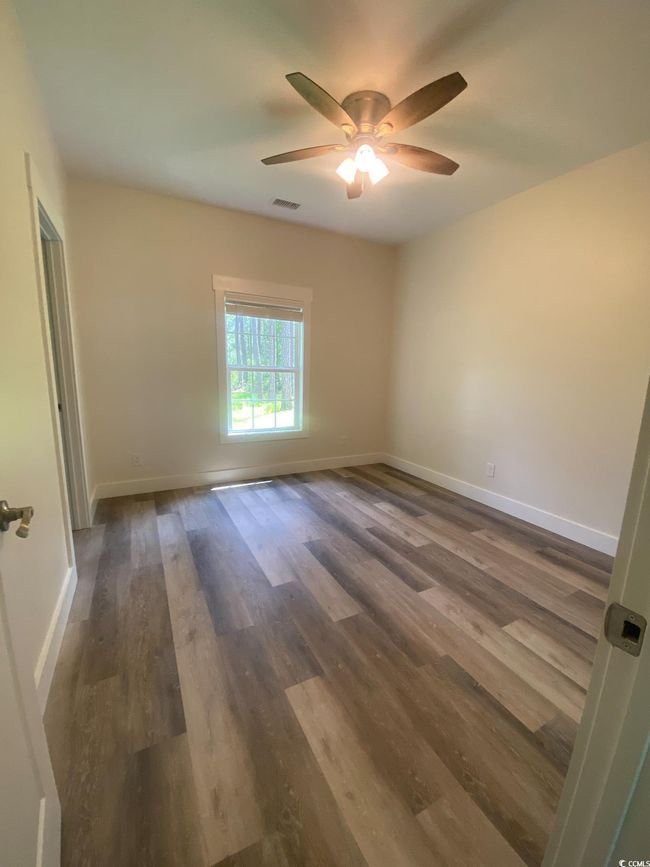 Empty room featuring ceiling fan and wood finished floors | Image 19